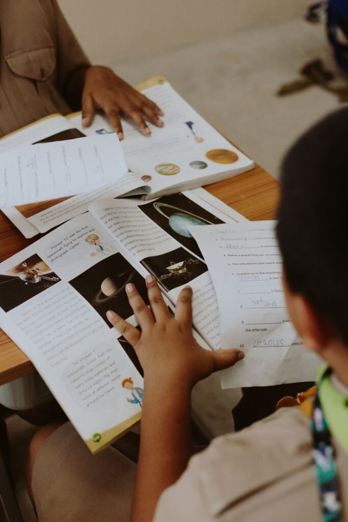 Two students engaging with planetary science materials in a classroom.