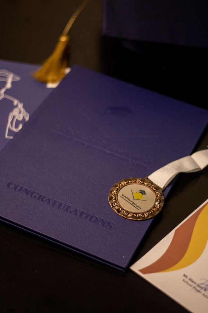 Close-up of a graduation diploma and medal, symbolizing academic achievement and celebration.