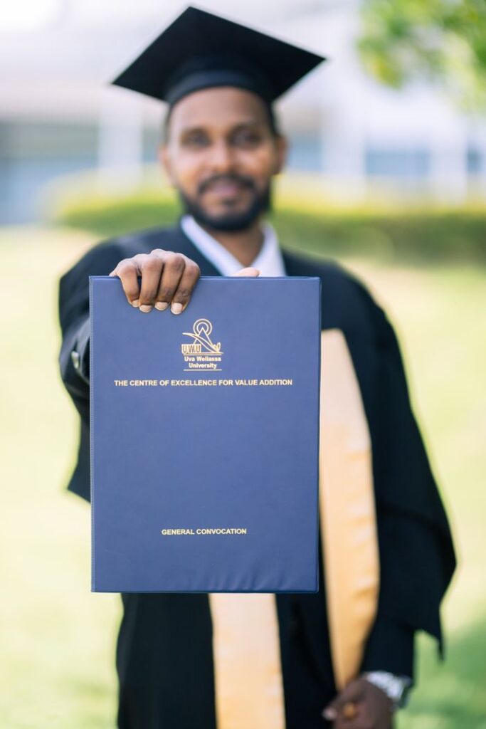 Young South Asian graduate with diploma at Hambantota campus graduation ceremony.