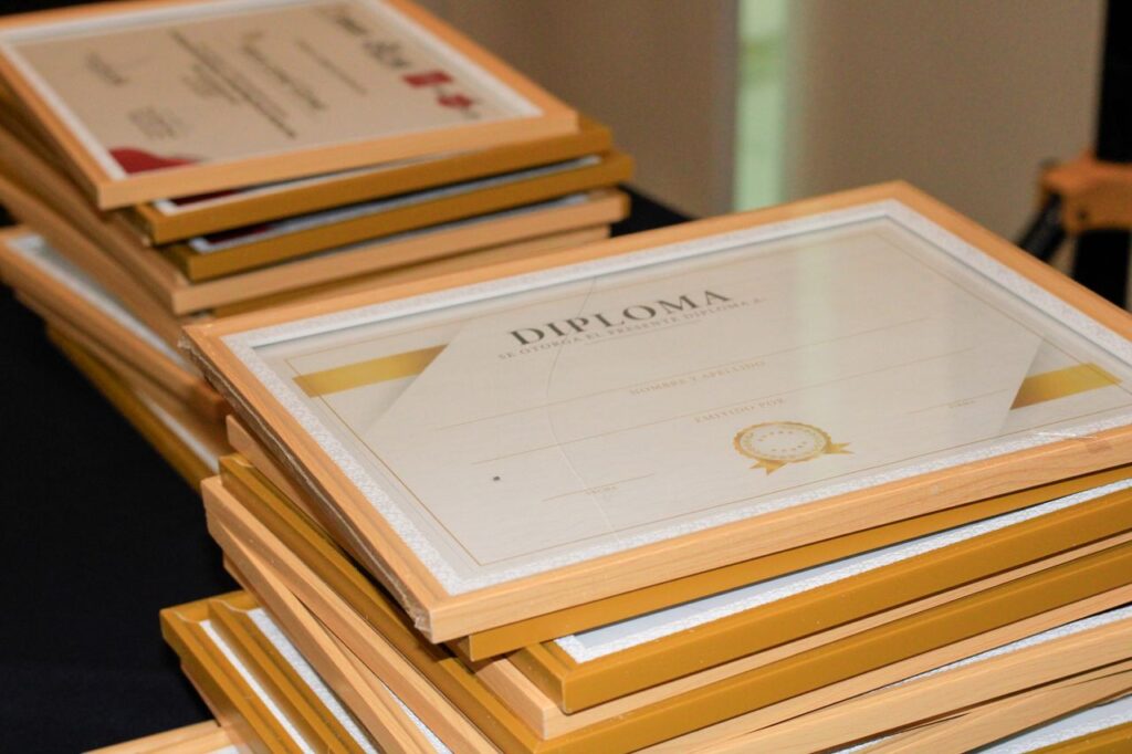 A stack of elegant framed diplomas prepared for an academic ceremony.