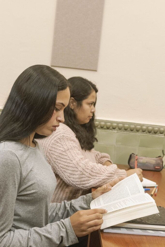Two students focused on studying inside a library in Montevideo, Uruguay.